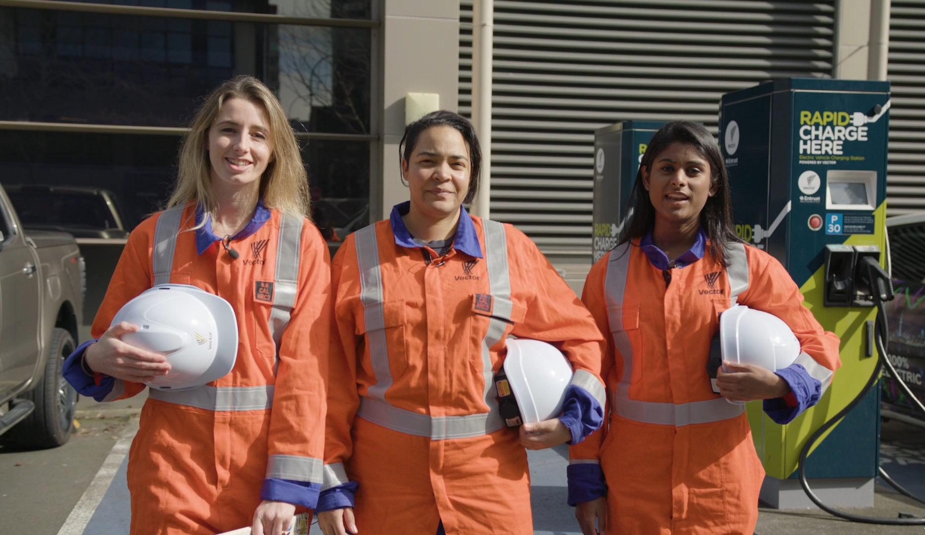 Photo of three women working at Vector Limited in overalls and carrying hard hats