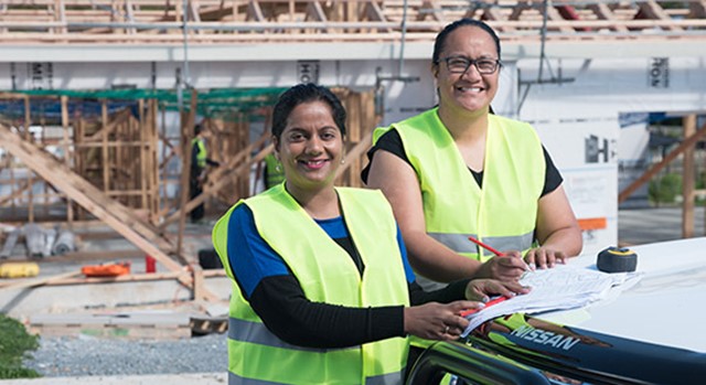 Two women working on a building site